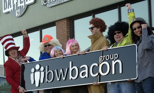 bacon team holding sign with logo