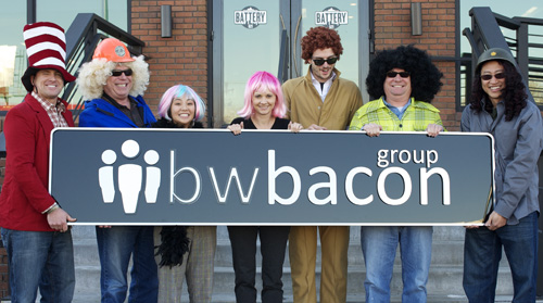 bwbacon team holding sign with logo